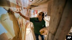 Coptic Christian Ayman William paints a mural depicting Samson at Mar Girgis Church, in the Zawiya al-Hamra neighborhood of Cairo, Egypt, April 24, 2017. William paints for the glory of God, unfazed by recent attacks against his fellow Coptic Christians in Egypt.