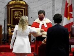 Canada's Governor General Julie Payette greets Supreme Court of Canada Chief Justice Richard Wagner as she arrives with Prime Minister Justin Trudeau to deliver the throne speech in the Senate chamber, Sept. 23, 2020, in Ottawa, Ontario.