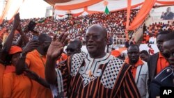 FILE - Burkina Faso presidential candidate Roch Marc Christian Kabore from the MPP party waves during a rally in Ouagadougou, Burkina Faso, Nov. 27, 2015. 