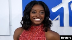 FILE - Olympic gymnast Simone Biles arrives at the 2016 MTV Video Music Awards in New York, Aug. 28, 2016.