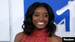 FILE - Olympic gymnast Simone Biles arrives at the 2016 MTV Video Music Awards in New York, Aug. 28, 2016.