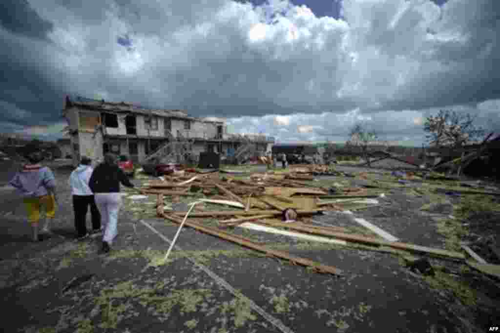 Debris is spread across the parking lot of an apartment complex from a tornado Thursday, April 28, 2011 in Glade Spring, Va. Several homes and trucks stops along I-81 were severely damaged near I-81. Five deaths have been reported. (AP Photo/Jeff Gentner)