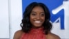 FILE - Olympic gymnast Simone Biles arrives at the 2016 MTV Video Music Awards in New York, Aug. 28, 2016.