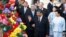 Chinese President Xi Jinping, front left, and his wife Peng Liyuan, front right, wave after arriving at Macao Airport, Dec. 18, 2019.