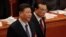 Chinese President Xi Jinping, left, and Chinese Premier Li Keqiang arrive at the opening session of China's National People's Congress at the Great Hall of the People in Beijing, Tuesday, March 5, 2019. 