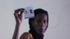 FILE—An election commission worker holds up a ballot paper at the start of the vote count, in a polling station in Dakar, Senegal, March 24, 2024. 