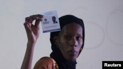 FILE—An election commission worker holds up a ballot paper at the start of the vote count, in a polling station in Dakar, Senegal, March 24, 2024. 