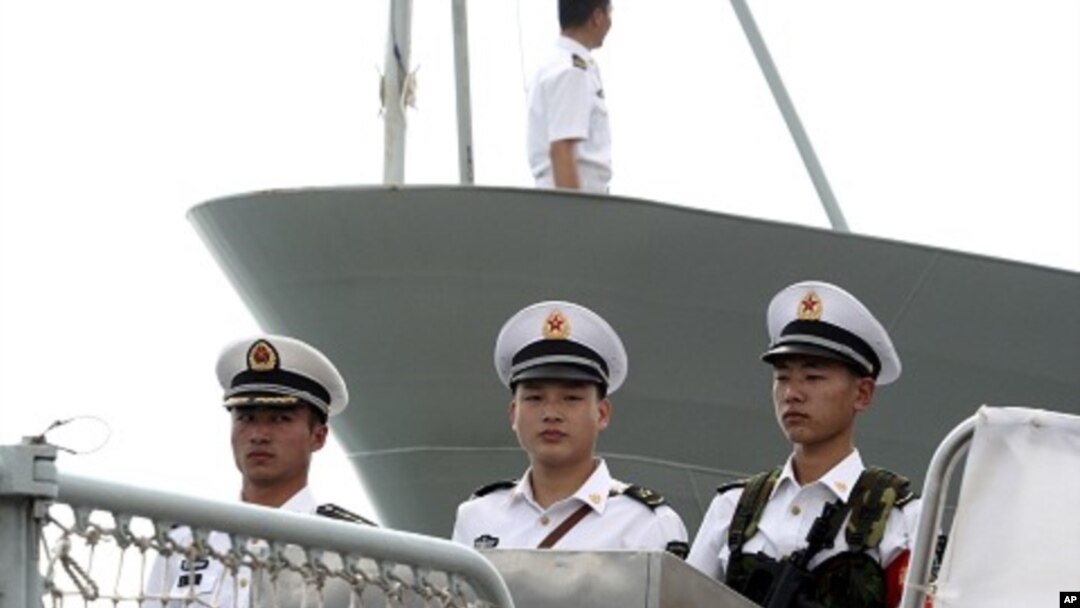 Chinese naval personnel stand at attention on the deck of the People's Liberation Army Navy's guided missile frigate FFG Zhoushan (file photo)