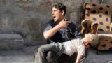 A Syrian man reacts as he carries the body of a boy following reported air strikes by government forces in the Halak neighbourhood in northeastern Aleppo.