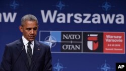 U.S. President Barack Obama listens to Polish President Andrzej Duda offering condolences before making statements following their meeting at PGE National Stadium in Warsaw, Poland, July 8, 2016. 