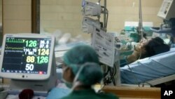 FILE - A hospital staffer monitors the vital signs of a suspected bird flu patient. Experts say the 3-D thread is a vast improvement over other biological diagnostic devices.