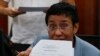 Maria Ressa, the award-winning head of a Philippine online news site Rappler that has aggressively covered President Rodrigo Duterte's policies, shows an arrest form after being arrested by National Bureau of Investigation agents in a libel case, Feb. 13, 2019.