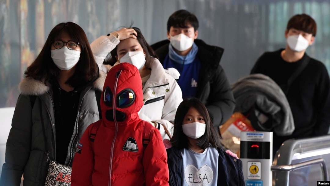 FILE - Passengers wearing masks to prevent a new coronavirus arrive at Incheon International Airport in Incheon, South Korea, Jan. 29, 2020. 