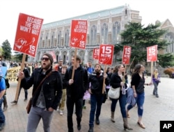 FILE - Protesters in Seattle, Washington, rally in support of raising the minimum wage to $15 an hour, April 1, 2015.