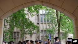 FILE - Future graduates wait for the procession to begin for commencement at Yale University in New Haven, Conn., May 24, 2010.