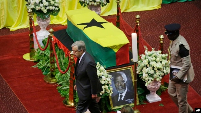 Current U.N. Secretary-General Antonio Guterres, left, pays his respects by the coffin of former U.N. Secretary-General Kofi Annan, draped with the Ghana flag, during a state funeral at the Accra International Conference Center in Ghana Thursday, Sept. 13, 2018.