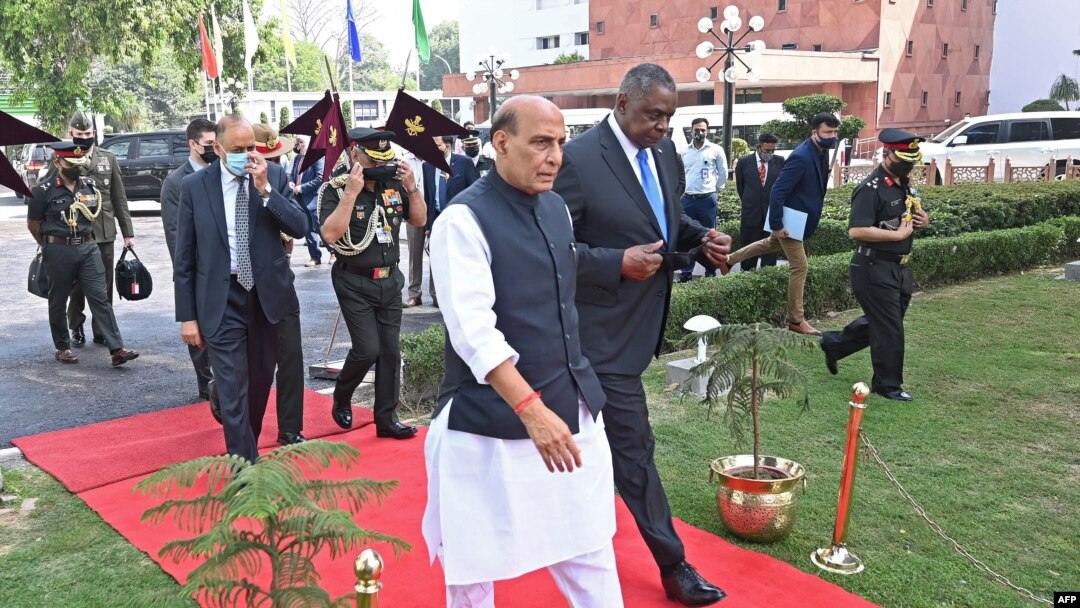 Indian Defense Minister Rajnath Singh walks with visiting U.S. Defense Secretary Lloyd Austin before reviewing an honor guard in New Delhi, March 20, 2021.