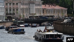 Tourists enjoy boat trips on the Moika River in Saint Petersburg on June 9, 2024.