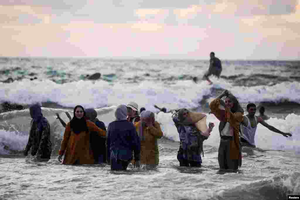 People enjoy themselves as they bathe in the Mediterranean Sea during the Muslim holiday of Eid al-Adha in Tel Aviv, Israel, July 21, 2021.