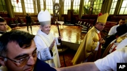 FILE - Reverend Juan Barros, center left, leaves after his consecration ceremony as bishop in Osorno, southern Chile, March 21, 2015.