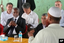 FILE - Former United Nations Secretary-General Kofi Annan, second left, listens to a Rohingya religious and community leader in the Internally Displaced People's camps during a visit by the Rakhine Advisory Commission in Thetkabyin village.