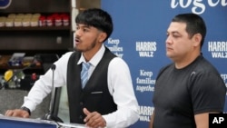 FILE - Billy and his father, no last name given, speak at a Democratic Party campaign event, about their experience of being separated when they crossed the U.S.- Mexico border during the Trump administration, Oct. 16, 2024, in Doral, Florida.