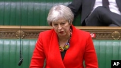 FILE - In this screengrab provided by the House of Commons, Britain's former prime minister Theresa May speaks during the debate in the House of Commons on the EU (Future Relationship) Bill in London, Dec. 30, 2020.