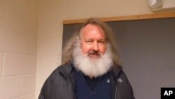 In a photo provided by the Vermont State Police, actor Randy Quaid stands in the Vermont State Police barracks in St. Albans, Vt., Friday, Oct. 9, 2015.