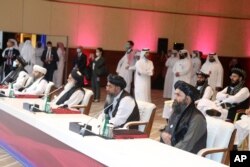 The Taliban delegation attends the opening session of peace talks between the Afghan government and the Taliban, in Doha, Qatar, Sept. 12, 2020.