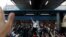 Thanathorn Juangroongruangkit of Thailand's progressive Future Forward Party gestures to his supporters at a sudden unauthorized rally in Bangkok, Thailand, Dec. 14, 2019