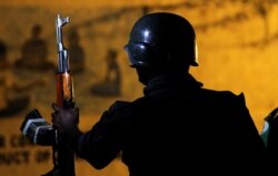 FILE - A Uganda People's Defense Forces soldier, part of the African Mission in Somalia (AMISOM) peacekeepers, is seen during a nighttime street patrol in Mogadishu, Somalia, 5, 2017.