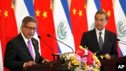 El Salvador's Foreign Minister Carlos Castaneda, left, speaks as China's Foreign Minister Wang Yi listens at a signing ceremony to mark the establishment of diplomatic relations between El Salvador and China at the Diaoyutai State Guesthouse in Beijing, China, Aug. 21, 2018.