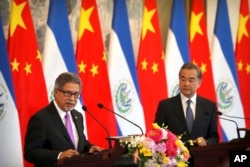 FILE - El Salvador's Foreign Minister Carlos Castaneda speaks as China's Foreign Minister Wang Yi listens at a signing ceremony to mark the establishment of diplomatic relations between El Salvador and China at the Diaoyutai State Guesthouse in Beijing.