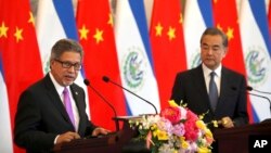El Salvador's Foreign Minister Carlos Castaneda, left, speaks as China's Foreign Minister Wang Yi listens at a signing ceremony to mark the establishment of diplomatic relations between El Salvador and China at the Diaoyutai State Guesthouse in Beijing, China, Aug. 21, 2018.
