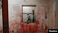 An employee works at a slaughterhouse near Nairobi, Kenya, Aug. 25, 2017. 