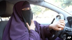 File - Kenza Drider, wearing a niqab, drives a car in Avignon, southern France.