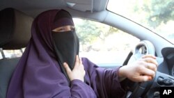 File - Kenza Drider, wearing a niqab, drives a car in Avignon, southern France.