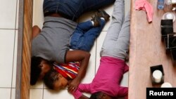 A mother and her children hide from gunmen at the Westgate mall in Nairobi Sept. 21, 2013. (Reuters)