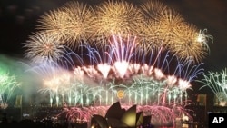 Fireworks explode over the Sydney Harbor Bridge and Opera House during a pyrotechnic show to celebrate the New Year, January 1, 2012.