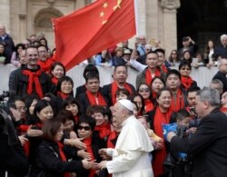 FILE - In this April 18, 2018 file photo, Pope Francis meets a group of faithful from China at the end of his weekly general audience in St. Peter's Square, at the Vatican.