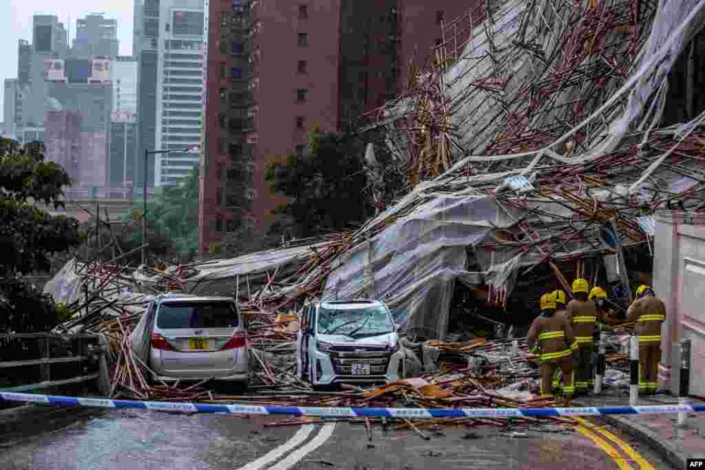 Rescuers work at the place where bamboo scaffolding by a high-rise building collapsed onto a road, following strong winds and heavy rain, in Hong Kong.