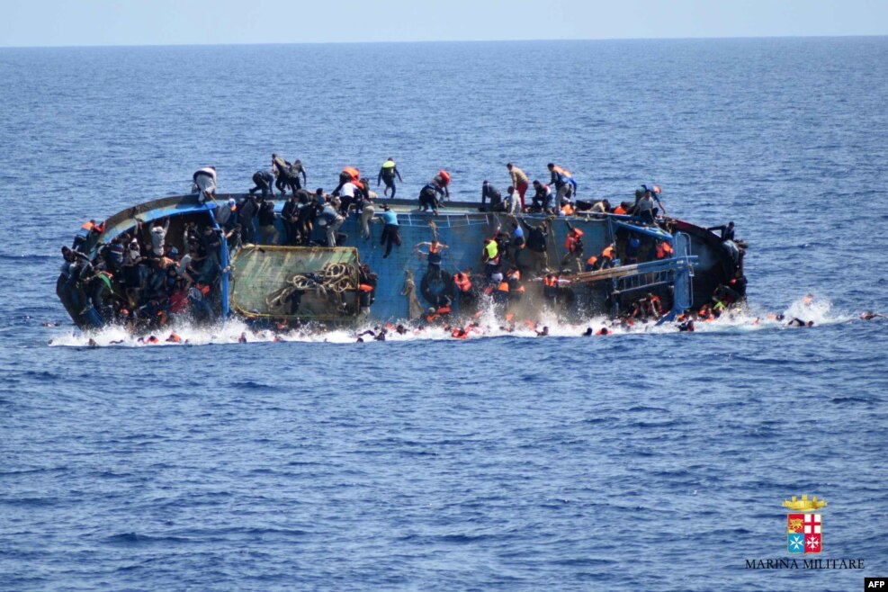 This handout picture by the Italian Navy (Marina Militare) shows the shipwreck of an overcrowded boat of migrants off the Libyan coast. At least seven migrants have drowned after the overcrowded boat overturned, the Italian Navy said. 500 people were pulled to safety but rescue operations were continuing and the death toll could rise, the navy said.