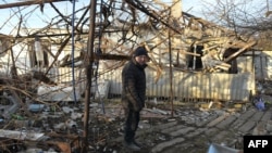 A local resident stands in the yard of his destroyed house following shelling, which local officials called a Ukrainian military strike, in the Donetsk region, Russian-controlled Ukraine, on Jan. 15, 2025.