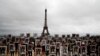 A hundred activists hold portraits of President Emmanuel Macron upside down to urge France to take action during the U.N. COP 25 climate talks in Madrid, Spain, during a gathering at Place du Trocadero facing the Eiffel Tower in Paris.