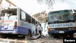 Damaged school buses are seen at the scene after a car exploded in a suicide attack near Mucassar primary and secondary school in Hodan district of Mogadishu, Somalia, Nov. 25, 2021. 