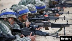 FILE - South Korean marines take part in a U.S.-South Korea joint landing operation drill as a part of the two countries' annual military training called Foal Eagle, in Pohang, South Korea, April 2, 2017.