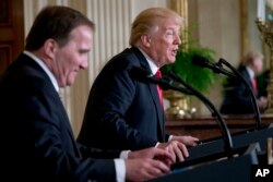 President Donald Trump accompanied by Swedish Prime Minister Stefan Lofven, left, speaks at a news conference in the East Room at the White House, March 6, 2018, in Washington.