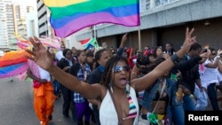 A woman holds her hands up during the Durban Pride parade where several hundred people marched through the city center in support of gay rights, July 30, 2011 file photo. 