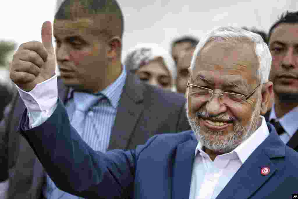 Rachid Ghannouchi, leader of the Tunisian moderate Islamist Ennahda Party, gestures before casting his vote at a polling station in Ben Arous, Tunisia, Oct. 26, 2014. 