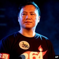 Wang Dan, one of the student leaders in the 1989 Tiananmen Square protests, takes part in a candlelight vigil for protesters crushed during the protests at the Liberty Square of the Chiang Kai-shek Memorial Hall, in Taipei, Taiwan, June 4, 2011.